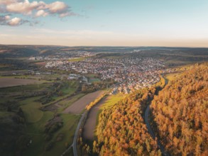 Aerial view of a town surrounded by autumnal forests and fields, Lindenrain industrial estate,
