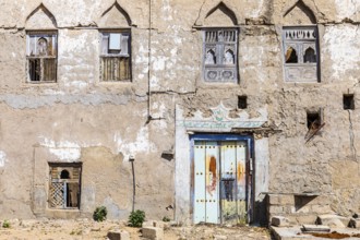 Old, weathered shutters and front door in the deserted neighbourhood of Mirbat, Dhofar Province,
