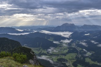 View from Edelweißlahner to the valley basin of Ramsau and Berchtesgaden with fog and sunbeams,