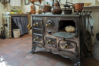 Antique cast-iron stove in kitchen inside 18th century clergy house Schriek at recreated village in