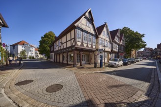 Historic half-timbered houses, city centre, concrete pavement, hard shoulder with parked cars,