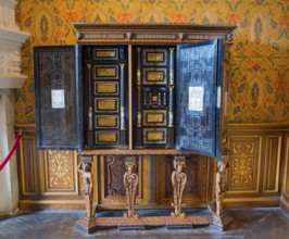 Decorative antique wooden cabinet with detailed engraving and open doors, Italian cabinet in the