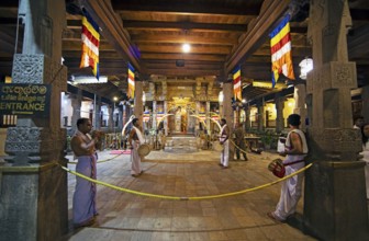 Drummers and flute players at a shrine in the Buddhist Temple of the Tooth or Sri Dalada Maligawa,