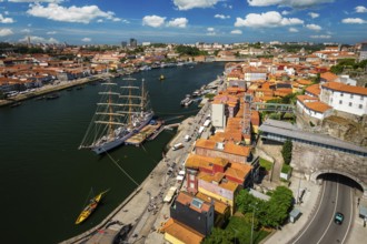 Aerial view of Porto city and Vila Nova de Gaia and Douro river with moored sailling ship from Dom