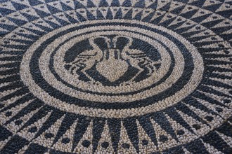 Detail of an artistically designed mosaic with a symmetrical pattern in black and white, thermal