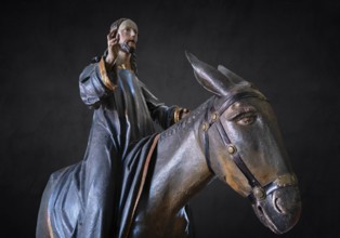 Christ on the palm donkey, detail on dark background, wooden figure from around 1880, Dominican