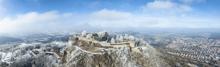 Aerial panorama of the snow-covered Hegau volcano Hohentwiel with Germany's largest castle ruins,