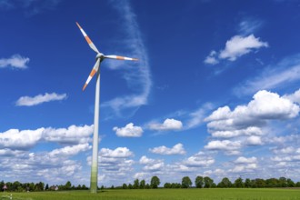 Wind turbine, wind energy plant from the manufacturer Enercon, blue sky with many white clouds,