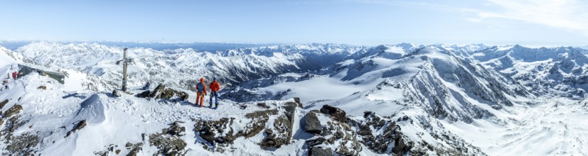 Two ski tourers on the summit of Cevedale, Alpine panorama, Aerial view, Snow-covered mountain