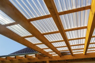 New patio roofing with wood and corrugated acrylic glass panels