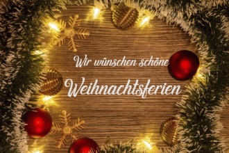 Christmas greetings: lettering WIR WÜNSCHEN SCHÖNE WEIHNACHTSFERIEN with Christmas decorations