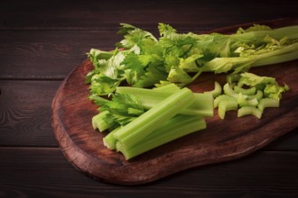 Fresh bunch of celery, top view, no people, on a dark background