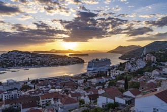Cruise ship Norwegian Escape in the harbour of Dubrovnik at sunset, Croatia, Europe
