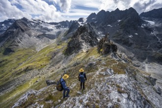 Two climbers on a mountain ridge, ascent to the summit of Mont de la Blana, view of rocky mountain