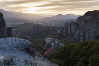 Hermitages between high cliffs, monasteries on sandstone formations, Meteora, sunset, Thessaly,