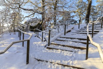 Stairs in a snow-covered rocky landscape on the ascent to the Bastei, turn-off to Kanapee Aussicht,