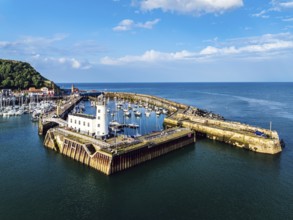 Scarborough Lighthouse and Harbour from a drone, Vincent Pier, Scarborough, North Yorkshire,