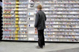 Ten-year-old boy in a shop with a surplus of Nintendo DS games, Germany, Europe