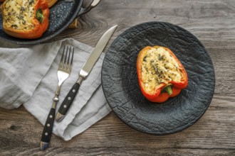 Close-up view of roasted bell peppers stuffed with goat cheese and mozzarella on wooden table