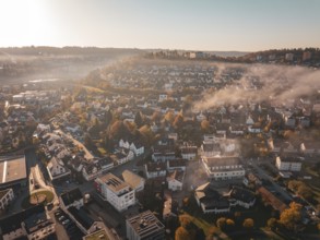 Town with streets and buildings under a foggy autumn atmosphere, Nagold, Black Forest, Germany,