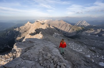 Mountaineer on a steep rocky ridge, impressive mountain landscape, view of the Höllental and the