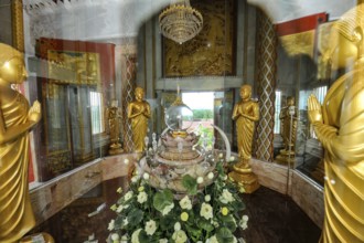 Reliquary with relics under glass in dome of tower in top of Chedi highest building in temple