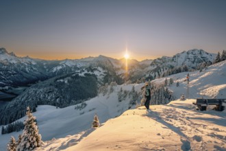 Summit bliss in the snow-covered winter landscape in the Tannheimer Tal in the Alps on the