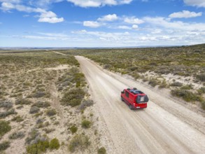 4x4 campervan drives along the road near Estancia la Maciega, Chubut, Argentina, South America