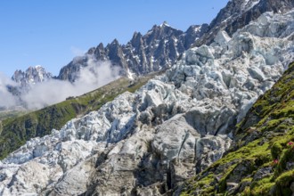 Glacier ice of the Glacier des Bossons, behind pointed mountain peaks, Chamonix, Haute-Savoie,