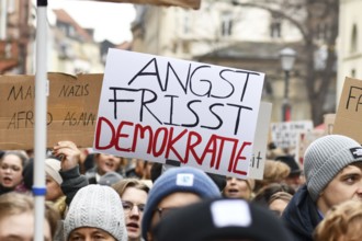 Heidelberg, Germany - February 12th 2025: Person holding up sign with text 'Fear eats democracy in