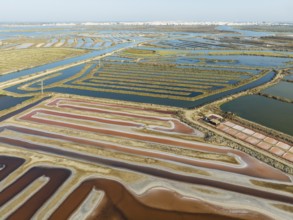 Saline ponds at the salt works near Chiclana de la Frontera. The orange-red colour depends on the