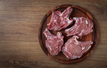 Raw calf meat, meat on the bone, meat for barbecue, cutting board, top view
