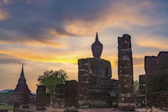 Sunset at a Buddha statue of the temple Wat Mahathat, UNESCO World Heritage Sukhothai Historical