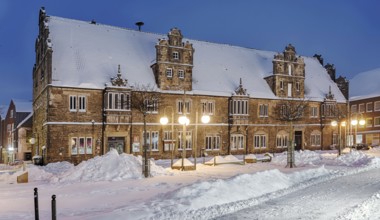 Marketplace Ratskeller winter snow illuminated Stadthagen Germany