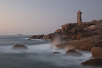 Lighthouse Mean Ruz at Ploumanac'h, Côtes d'Armor in the last evening light, with light on