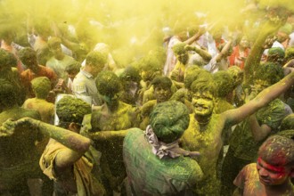 Revellers dancing in the beat of music as they celebrate Holi on a street, the Hindu spring