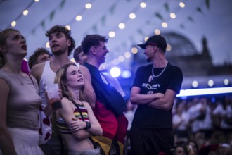 Scenes in the fan zone on Platz der Republik in front of the Reichstag building taken in Berlin, 29