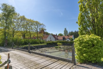 Risinge Herregaard, Ullerslev, Fyn manor house, moat, wooden bridge, trees, island of Funen,