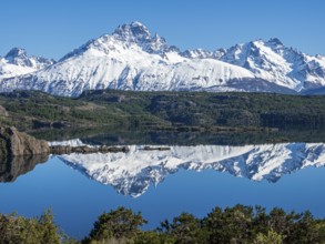 The snow-covered Mt. Cerro Castillo is reflected in a lake, Patagonia, Chile, South America