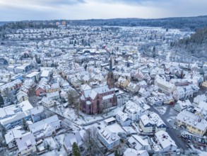Panoramic view of a snow-covered town with a church in the centre, Nagold, Black Forest, Germany,