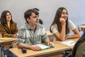 Group of happy and smiling students listening to their teacher in a classroom at their university
