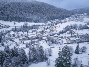 A small village in a snow-covered hilly landscape surrounded by forests, Enzklösterle, Calw