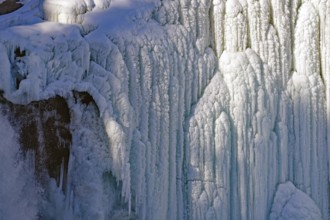 Ice formations at a frozen waterfall, fascinating structures and layers, winter, Sweden's highest