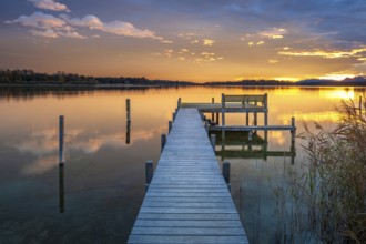 Footbridge on Lake Chiemsee at sunrise, with the Chiemgau Alps in the background, Chiemgau,