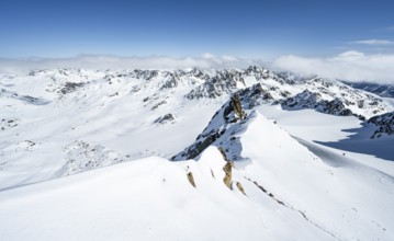 Mountain ridge of Piz Kesch, ascent on Piz Kesch or Piz d'Es-cha in winter, spectacular mountain