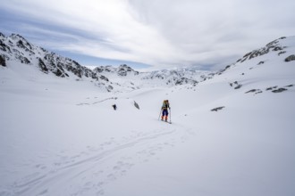 Ski tourer in mountain landscape with snow, ascent to Grialetsch Scharte, Bündner Haute Route,
