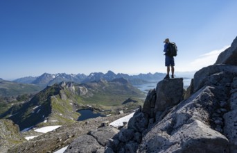 View of mountains and fjord landscape, mountain panorama, mountaineer at the summit of Rundfjellet,