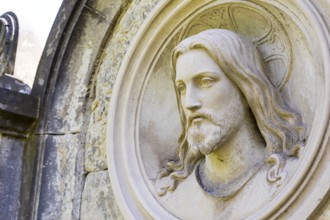 Head of Christ as a medallion at the cemetery in Lichtenstein, Saxony, Germany, Europe
