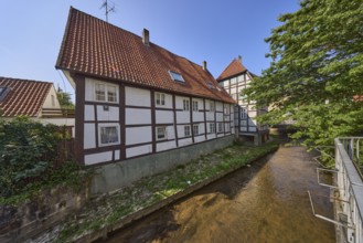 Half-timbered house against a cloudless blue sky on the Salze river in the city centre of Bad