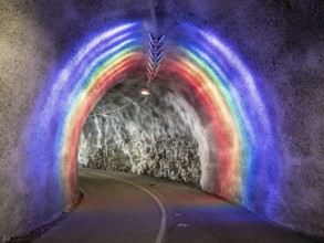 Colorful illuminated tunnel for bicycles and pedestrians leads up to Hardanger suspension bridge,
